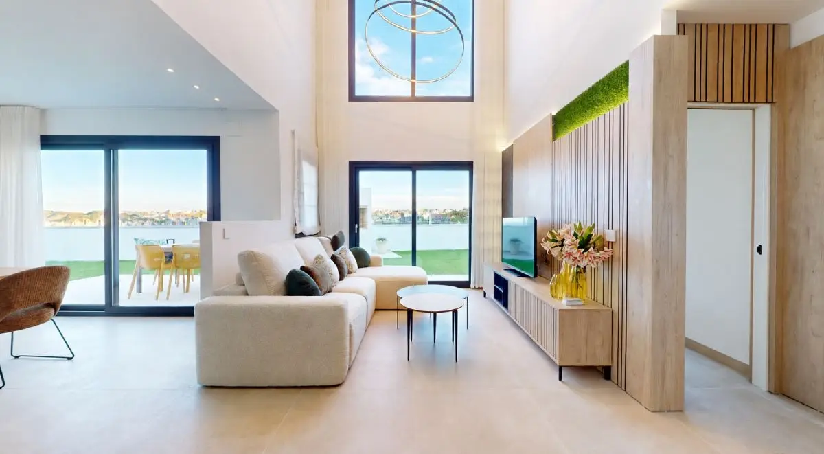 A modern, light-filled living room with large windows and open-plan spaces, designed to promote a sense of well-being at home
